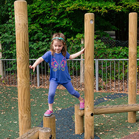 Girl walking on a balance beam